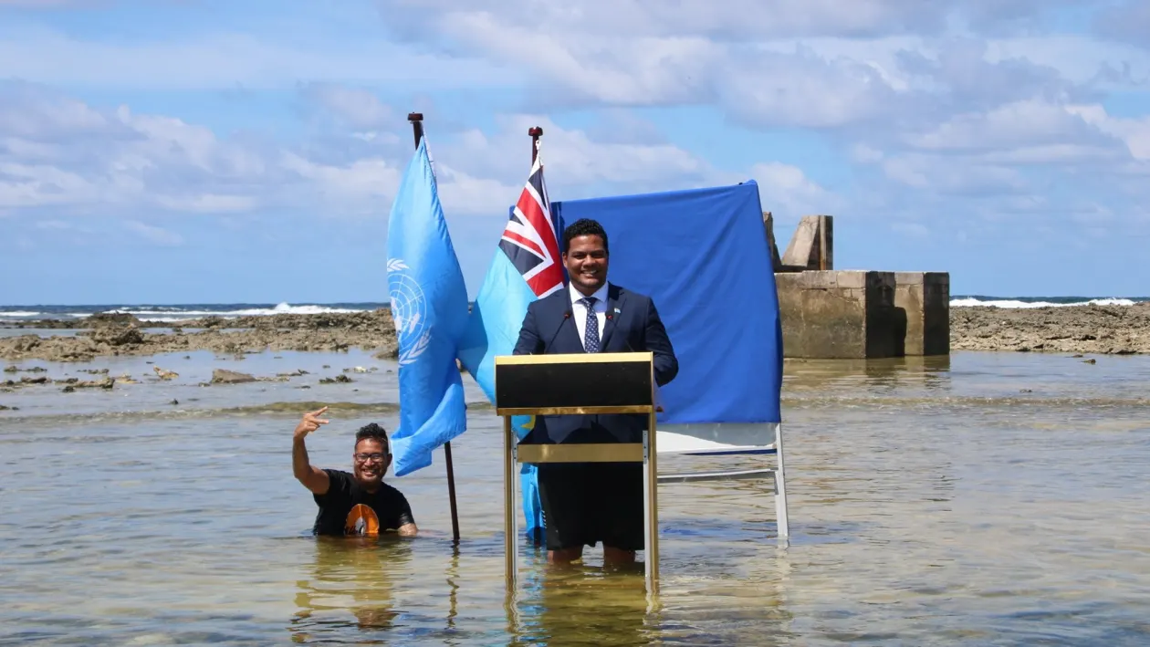 Simon Kofe, foreign minister of Tuvalu, delivers a speech to the United Nations Climate Change Conference in Glasgow (COP26) from the water off of Funafuti, the capital of Tuvalu on November 5, 2021.